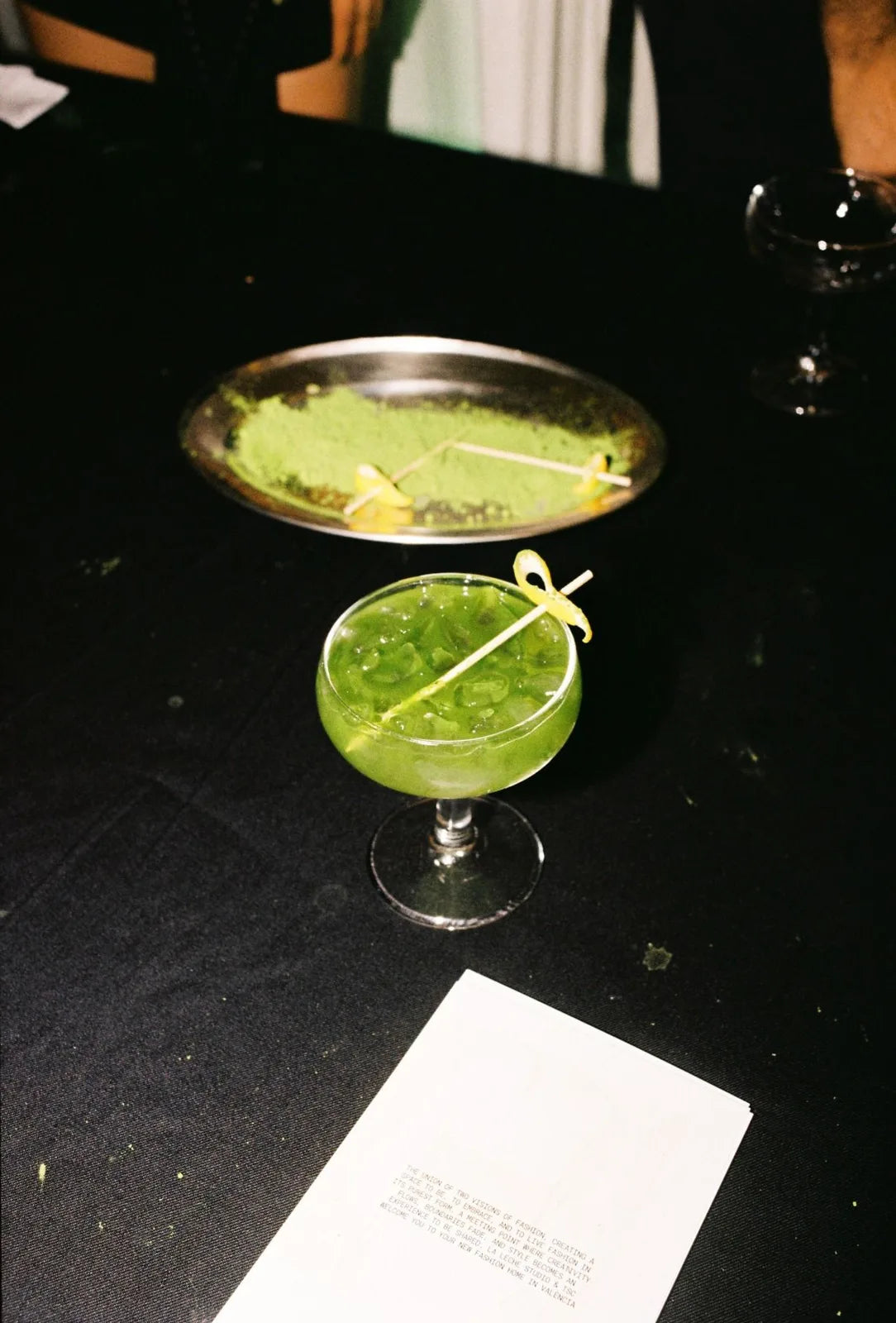 A matcha drink in a coupe glass