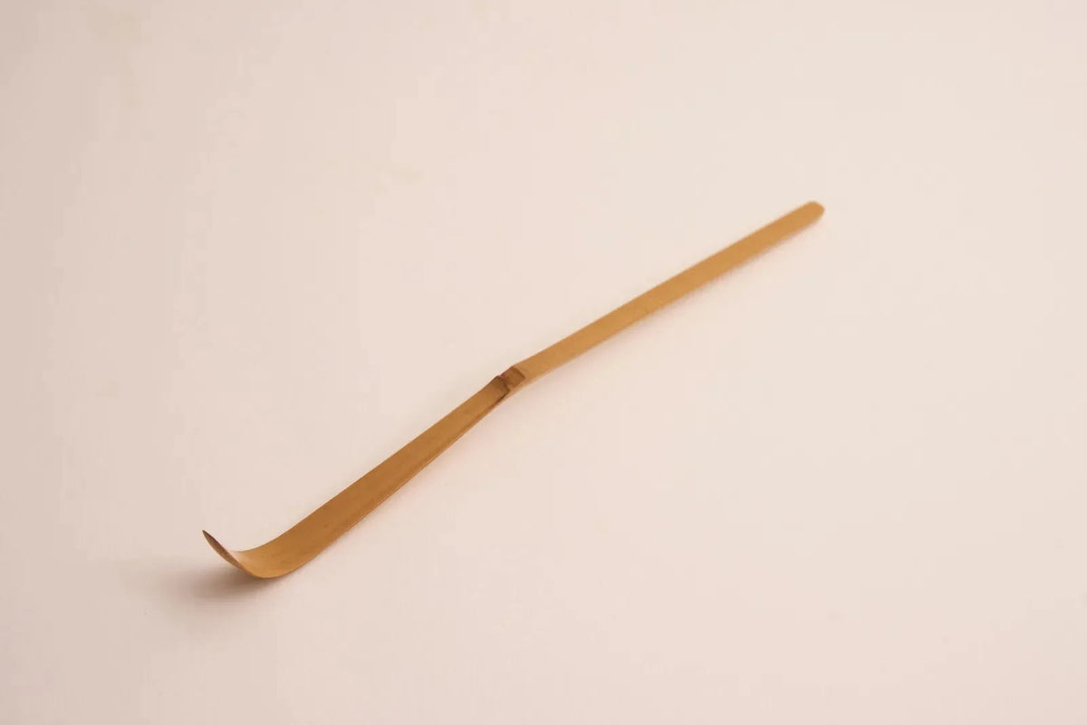 A bamboo scoop on a pink ground