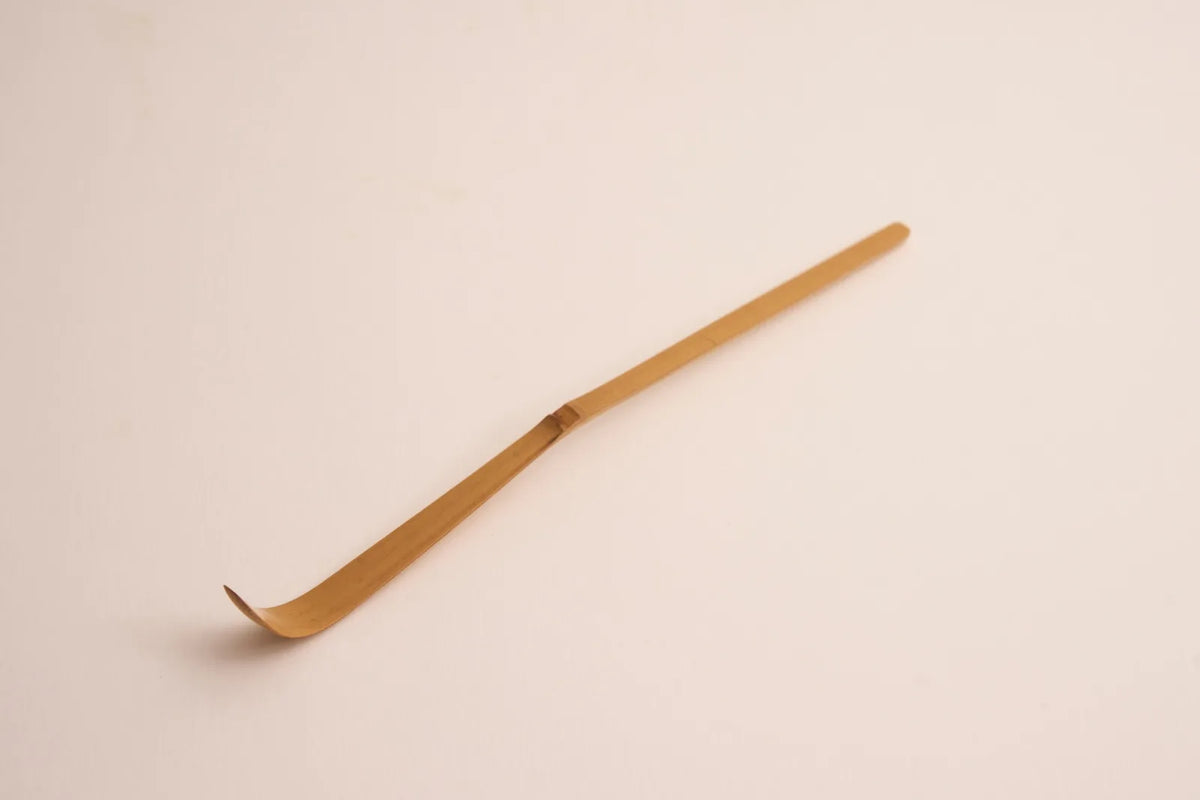 Bamboo scoop on a pink ground