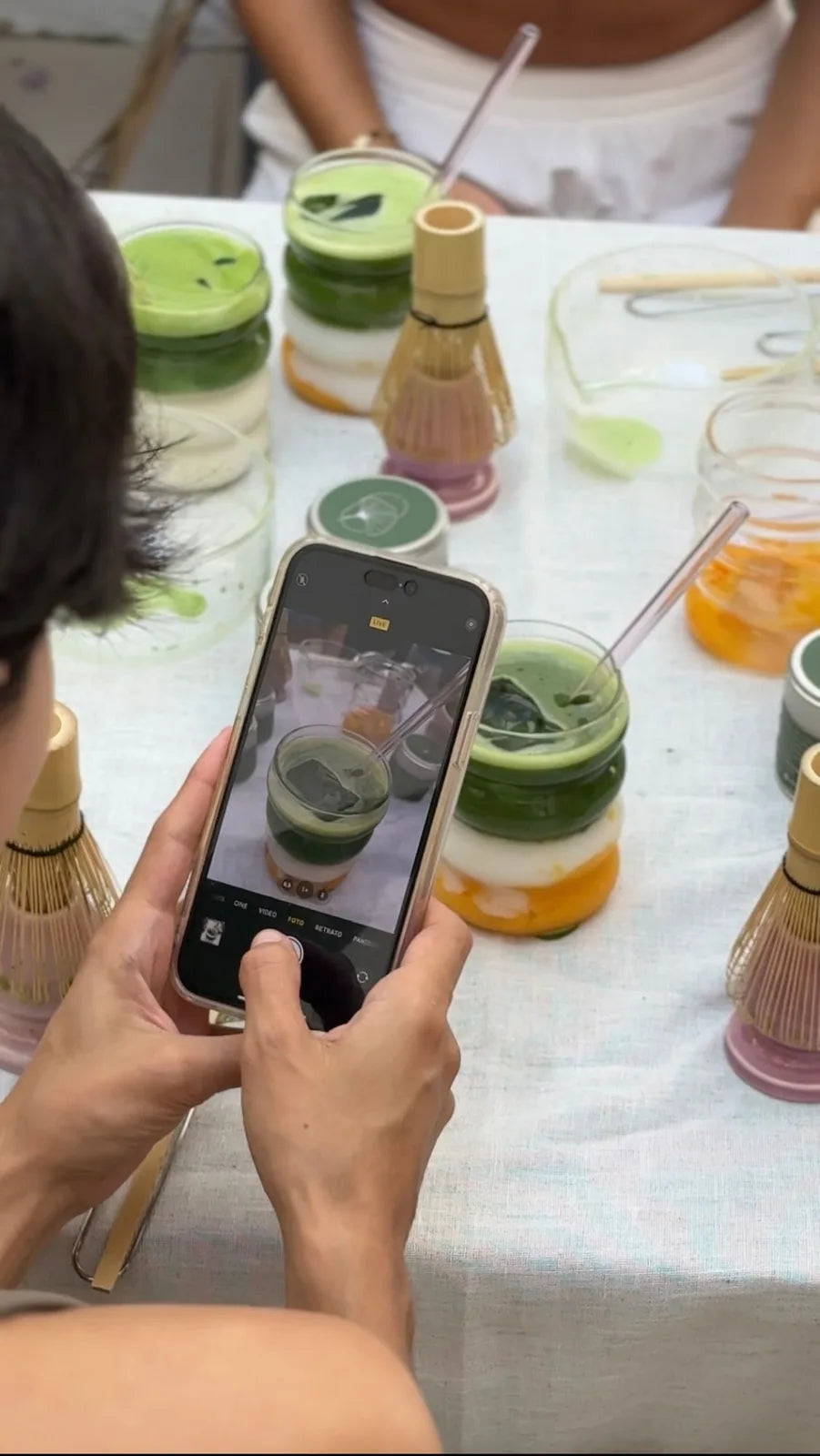 A table of layered iced matcha drinks at an Efflo event