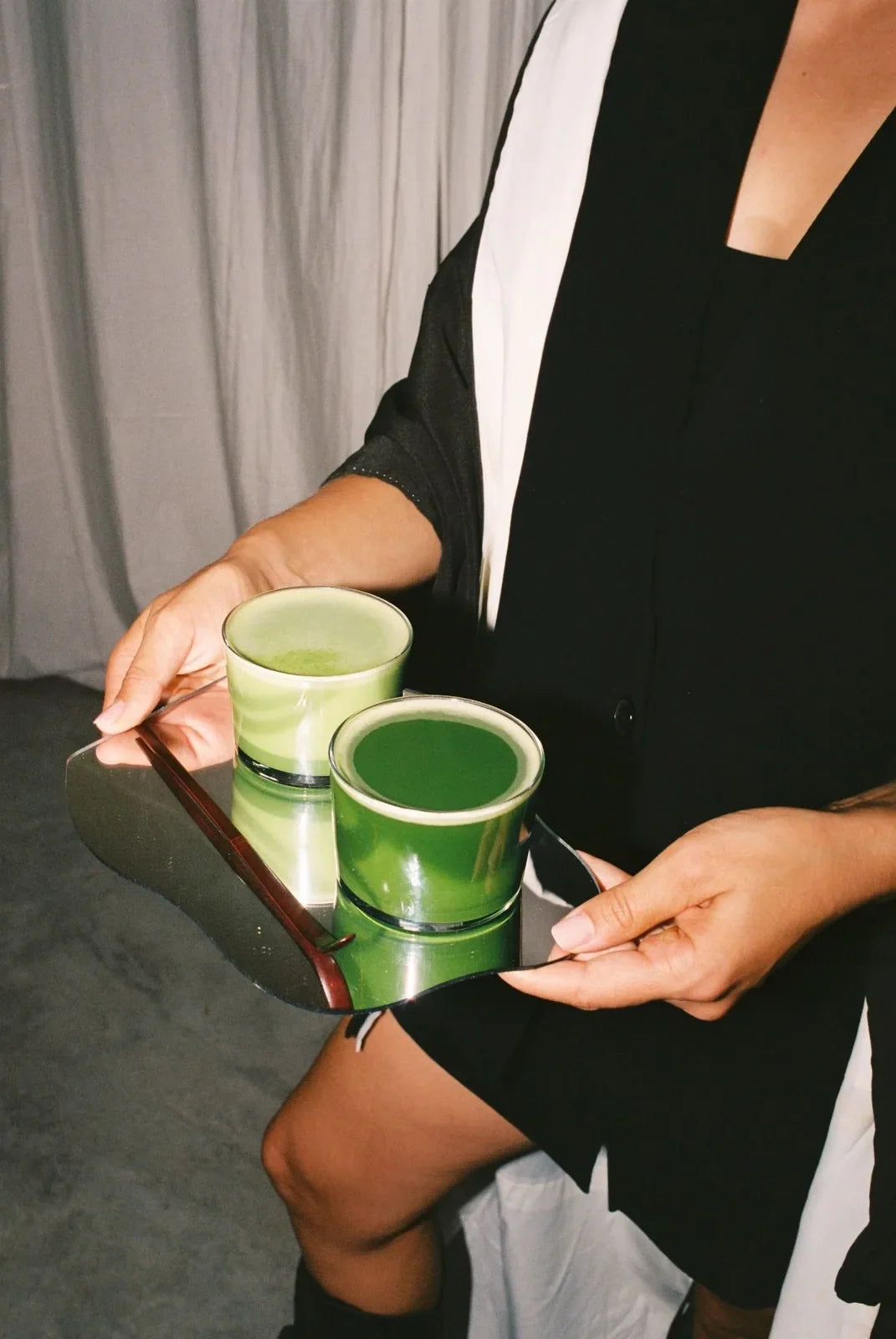 A tray with two glasses of matcha